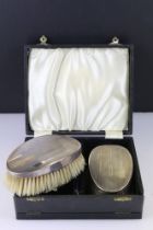 Pair of silver backed clothed brushes in fitted box. Hallmarked Birmingham 1941.