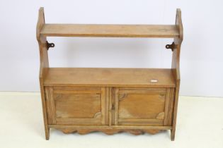 Victorian oak wall hanging cabinet shelf having two shelves to top having twin door cabinet below.