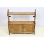 Victorian oak wall hanging cabinet shelf having two shelves to top having twin door cabinet below.