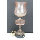 Late 19th / early 20th century oil lamp, the pink glass frosted shade with floral detail, over a