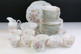 Early 20th Century tea service having a white ground with pink floral sprays and gilt rims. Marked