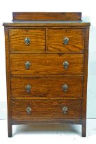 Early 20th Century oak chest of drawers having a gallery backed top, two over three drawers each
