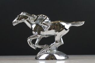 A nickel plated white metal trophy in the form of a horse and jockey.