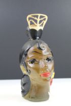 An mid 20th century bottle in the form of a female head complete with contents.