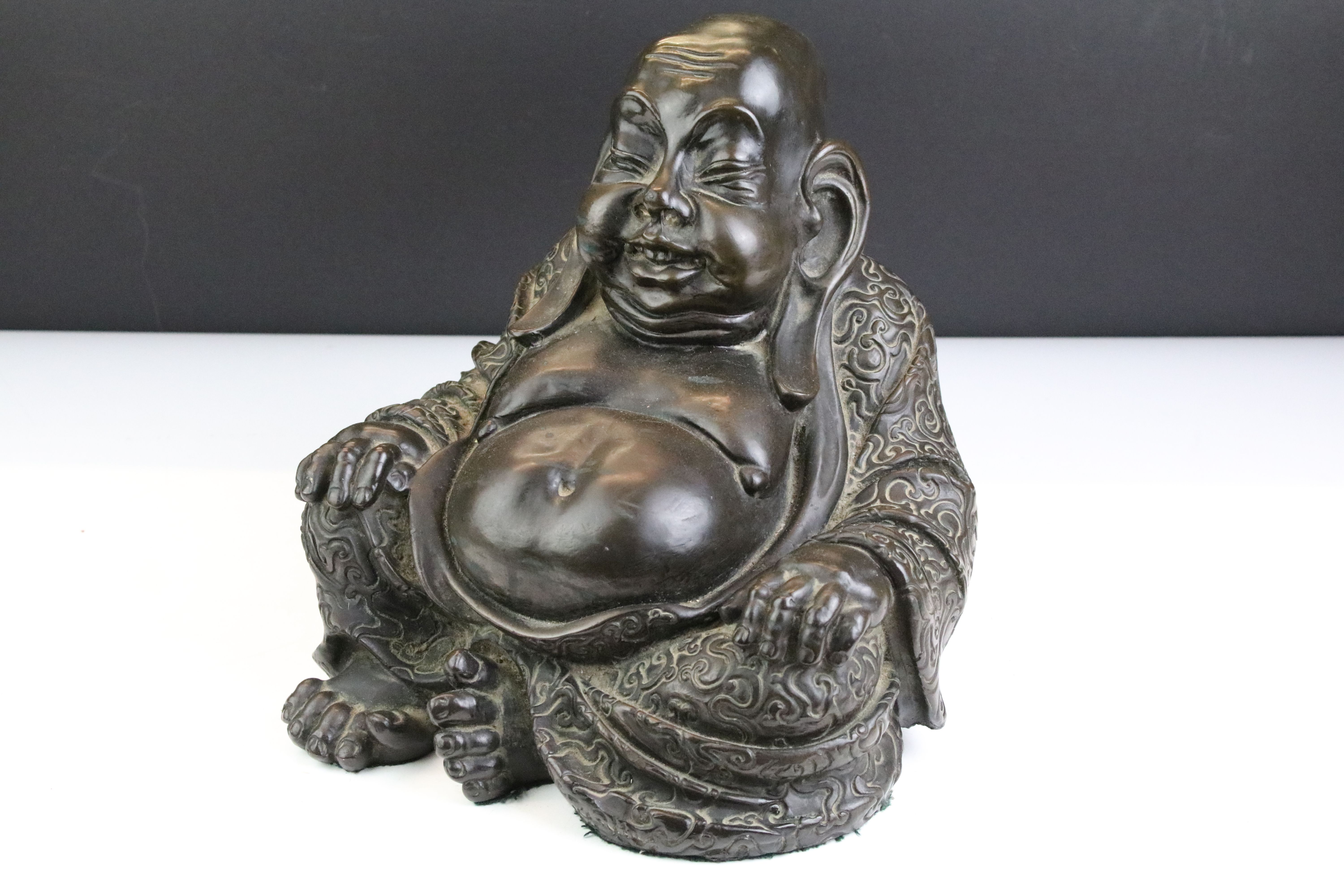 Large cast resin laughing Buddha figurine modelled seated in the lotus position. Measures 25cm tall.