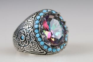 A ladies dress ring set with large centre stone surrounded by small turquoise stones, marked 925