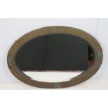 Early 20th Century Arts and Crafts oval copper framed mirror having hammered detailing with oval