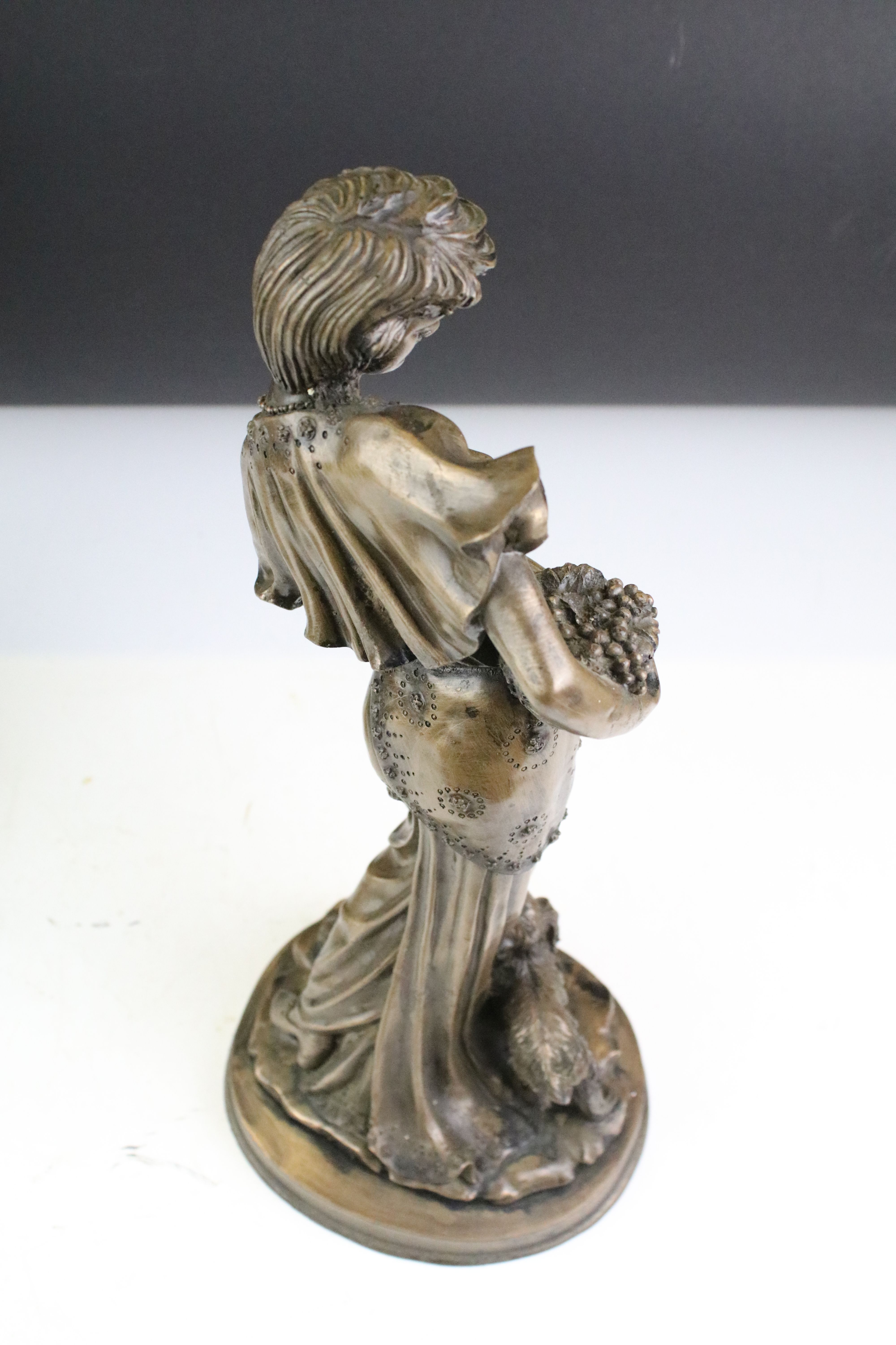 Two 20th Century cast resin faux bronze figurines in the form of a female figure holding a basket of - Image 5 of 8