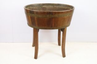 Late 19th / early 20th Century cellarette / planter having brass bindings raised on curved block