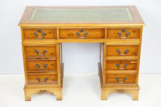 20th Century walnut veneered twin pedestal desk having a green leather top with three drawers to