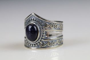 A ladies ring set with an amethyst cabochon, marked 925 to the inner shank.