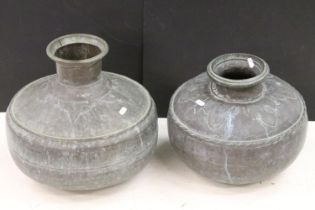 Two Indian copper hammered water vessels each of round form with open tops, with hammered