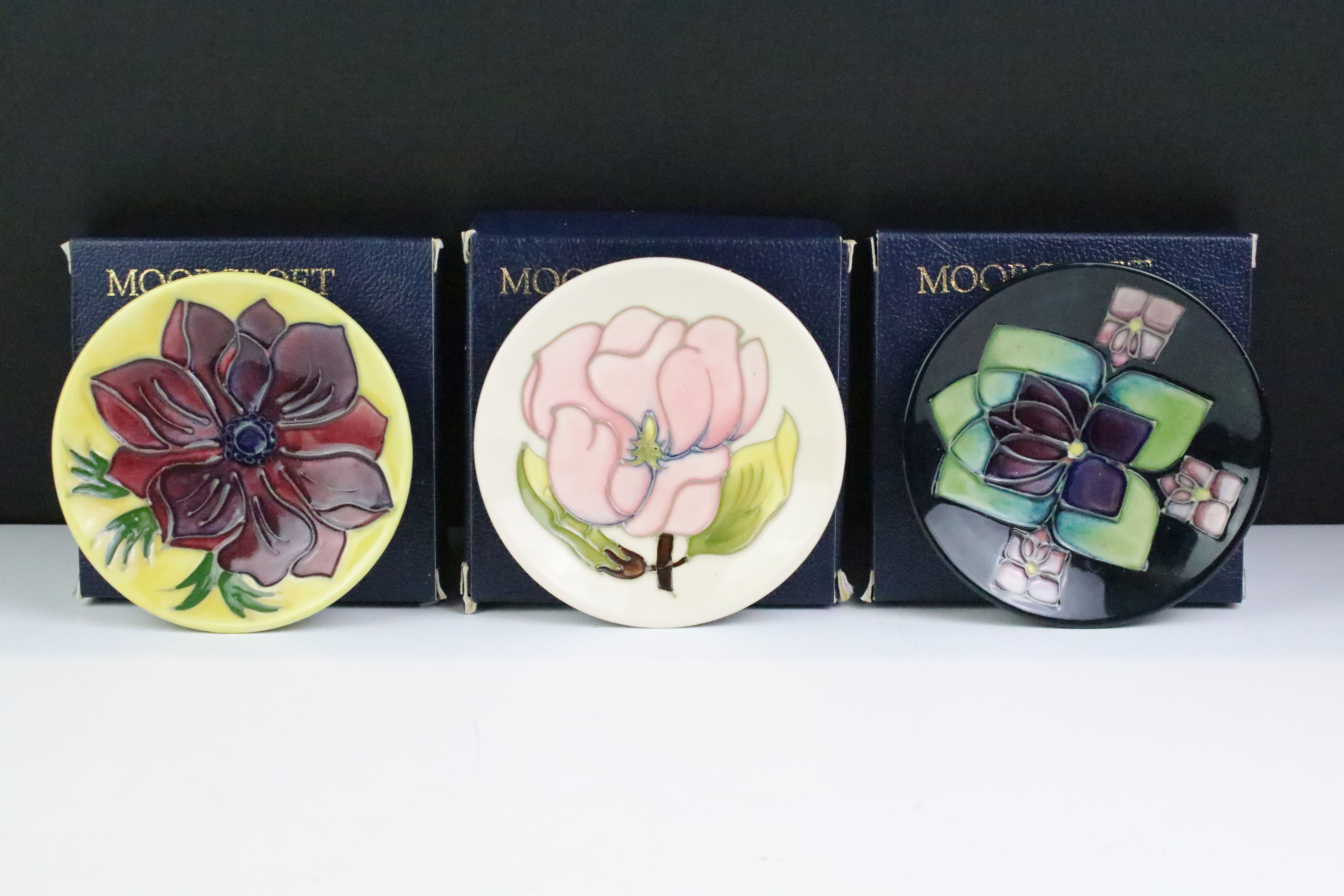 Three boxed Moorcroft pottery pin dishes to include Violet, Anemone on yellow ground & Magnolia on