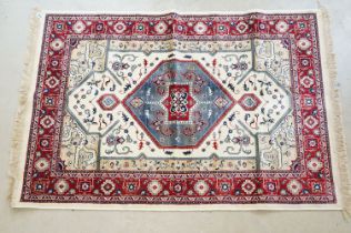 Ivory ground Kashmir carpet with Aztec medallion design, approx 170cm x 115cm