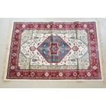 Ivory ground Kashmir carpet with Aztec medallion design, approx 170cm x 115cm