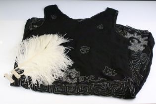 1920's silk lined black beadwork dress with Greek key style design, together with feather hair