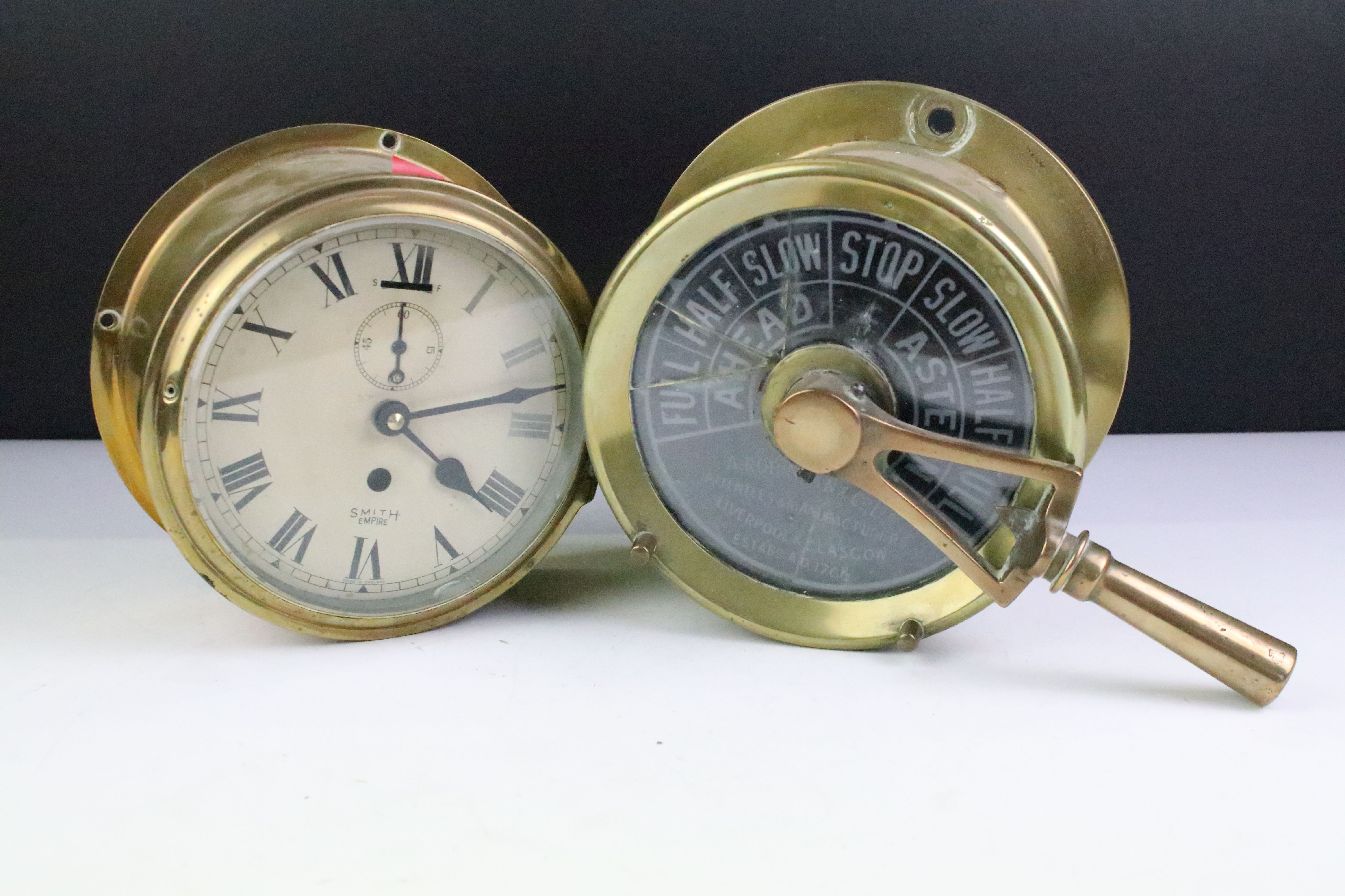 Early 20th Century A Robinson & Co brass cased ships telegraph together with a Smiths Empire brass