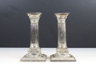 A pair of silver plated corinthium column candlesticks with rams head decoration, height approx 17cm