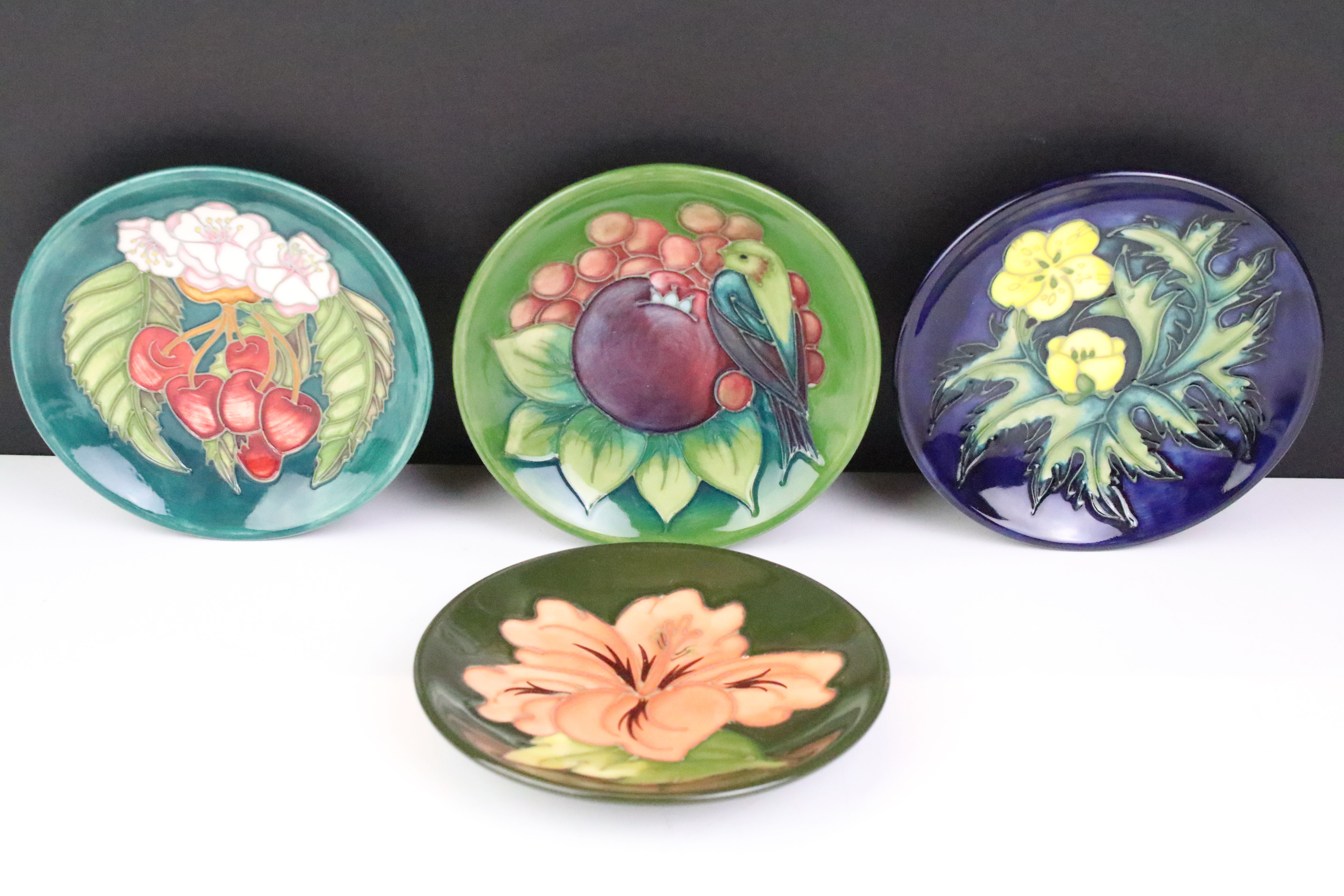 Four Moorcroft small shallow dishes, comprising: Hibiscus pattern, Finch and Fruit pattern,