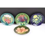 Four Moorcroft small shallow dishes, comprising: Hibiscus pattern, Finch and Fruit pattern,