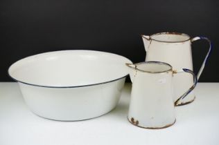 Group of vintage enamel ware to include bowl, two jugs. Bowl measures 39cm diameter.