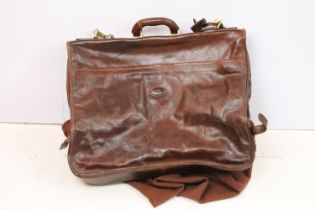 The Bridge brown leather folding garment bag with brass hard ware and dust bag.