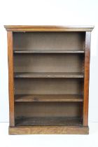 Antique mahogany open shelved book case having a flared top with pedestal base and three shelves