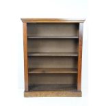 Antique mahogany open shelved book case having a flared top with pedestal base and three shelves