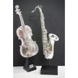 Two resin musical instrument models to include a violin and saxophone, with chrome effect finish. (