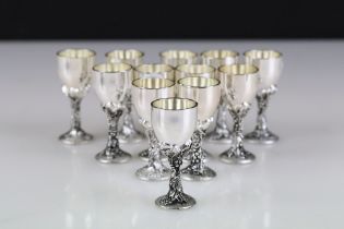 A collection of twelve silver plated menu holders in the form of wine goblets.