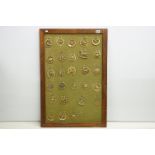 Collection of antique horse brasses mounted to canvas covered board and framed. Measures 97 x 66cm.