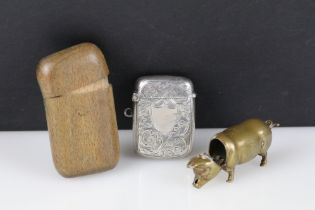 Three Vesta Cases including Brass in the form of a Pig (a/f), Silver Engraved (Birmingham 1904)