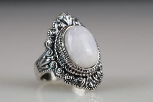 A ladies dress ring with central moonstone cabochon, marked 925 to the inner shank.