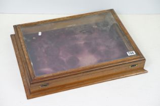 Antique mahogany glass topped table top display cabinet having brass locks to front. Measures 8 x 56