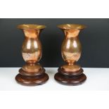 Pair of Chinese Coppered Bronze Vases with prunus blossom engraving, raised on wooden stands, 22cm