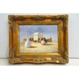 Gilt swept framed oil painting of a busy Victorian beach scene with congregation of people besides