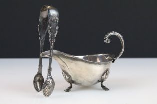 A fully hallmarked sterling silver cream jug together with a set of hallmarked silver sugar nips.