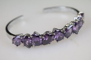 A ladies bracelet with with nine teardrop amethyst, marked 925 to the verso.