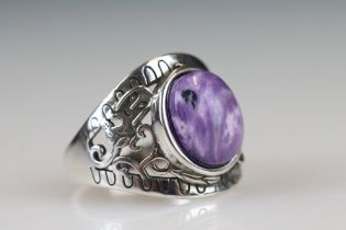 A 925 sterling silver ladies ring with purple cabochon central stone with decorative shoulder