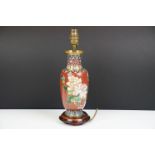 Cloisonne Table Lamp decorated with chrysanthemums on a red ground, raised on a wooden stand, 34cm