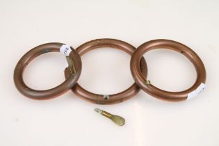 A collection of three agricultural copper pig / cattle nose rings.