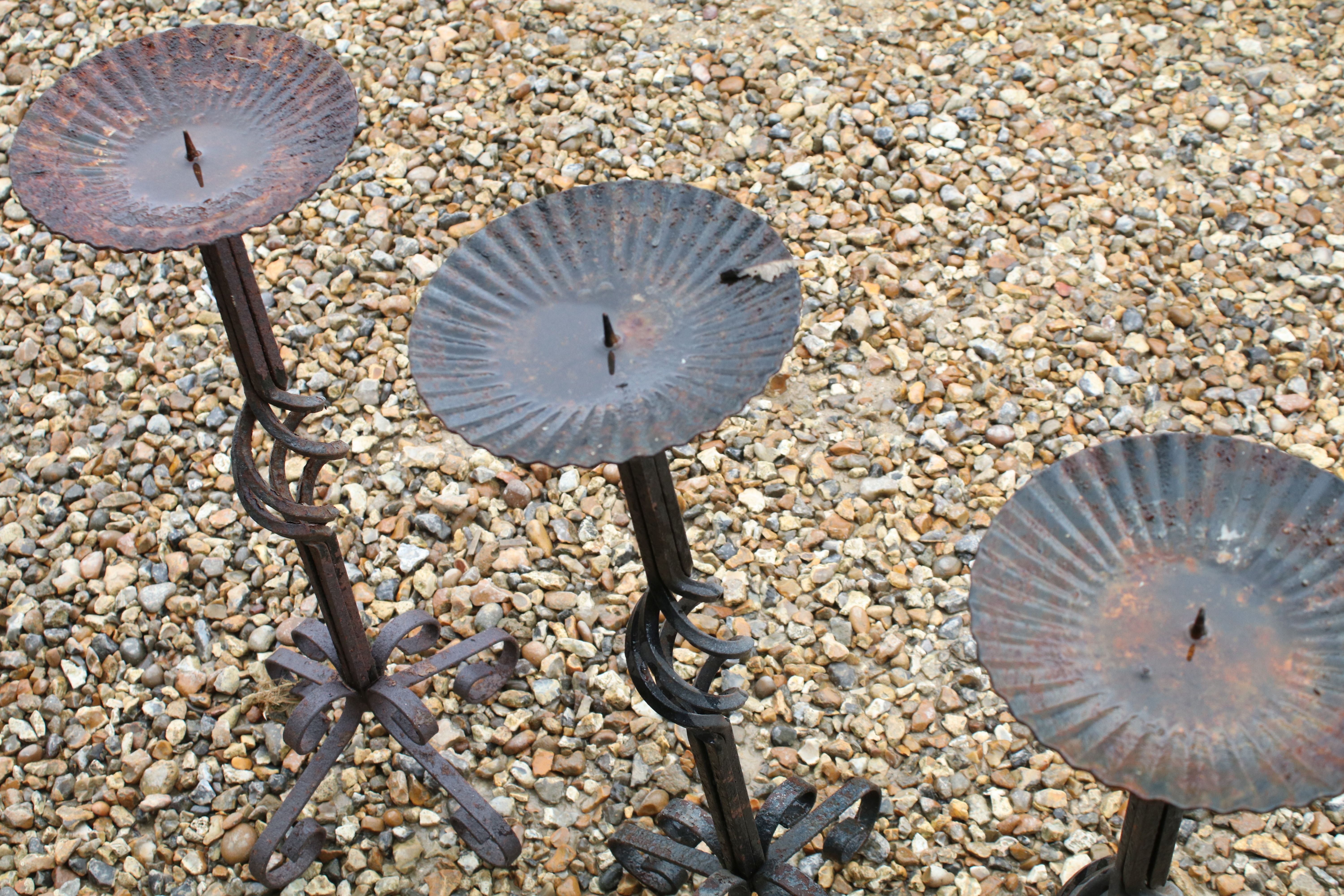 Set of three wrought iron floor standing candlesticks with spiralling to support, approx 62cm high - Image 3 of 4