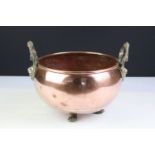 Copper Circular Planter with rolled rim and two brass lion / stag head handles and three lion paw