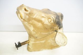 Life sized foam cows head with gold finish, attached to metal pole with plastic mount