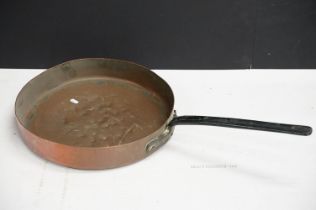 Antique copper frying pan with cast iron handle. Measures 41cm diameter.