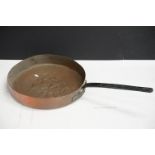 Antique copper frying pan with cast iron handle. Measures 41cm diameter.