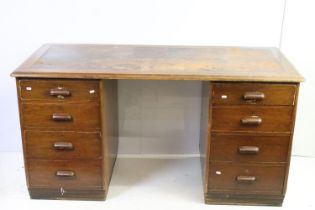 Mid century mahogany twin pedestal desk with leather inset top, above an arrangement of eight