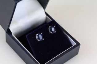 Pair of sapphire stud earrings set on silver posts