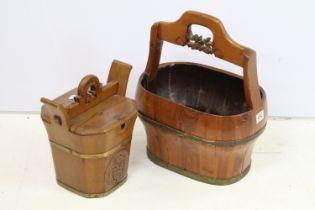 Two brass bound wooden buckets with carved detail and single handles, the largest being a coopered