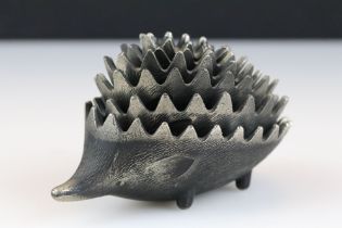 Metal hedgehog ashtray, each layer lifting to reveal a smaller hedgehog. Measures approx 11cm long